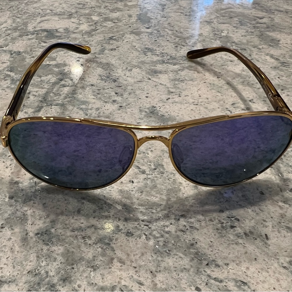 Gold Oakley Feedback Women’s  Polarized Sunglasses with purple lenses.